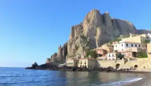 a building next to a rocky cliff
